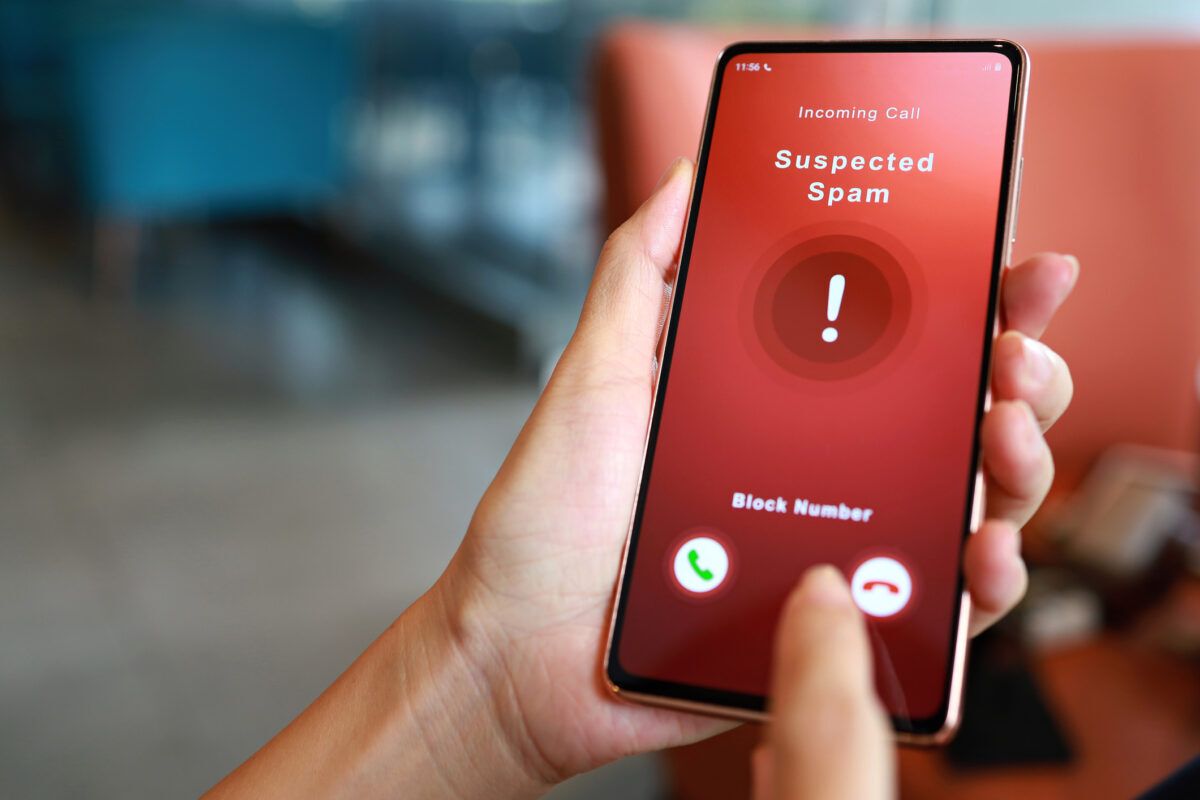 Person receiving suspected spam call on smartphone from an unknown caller