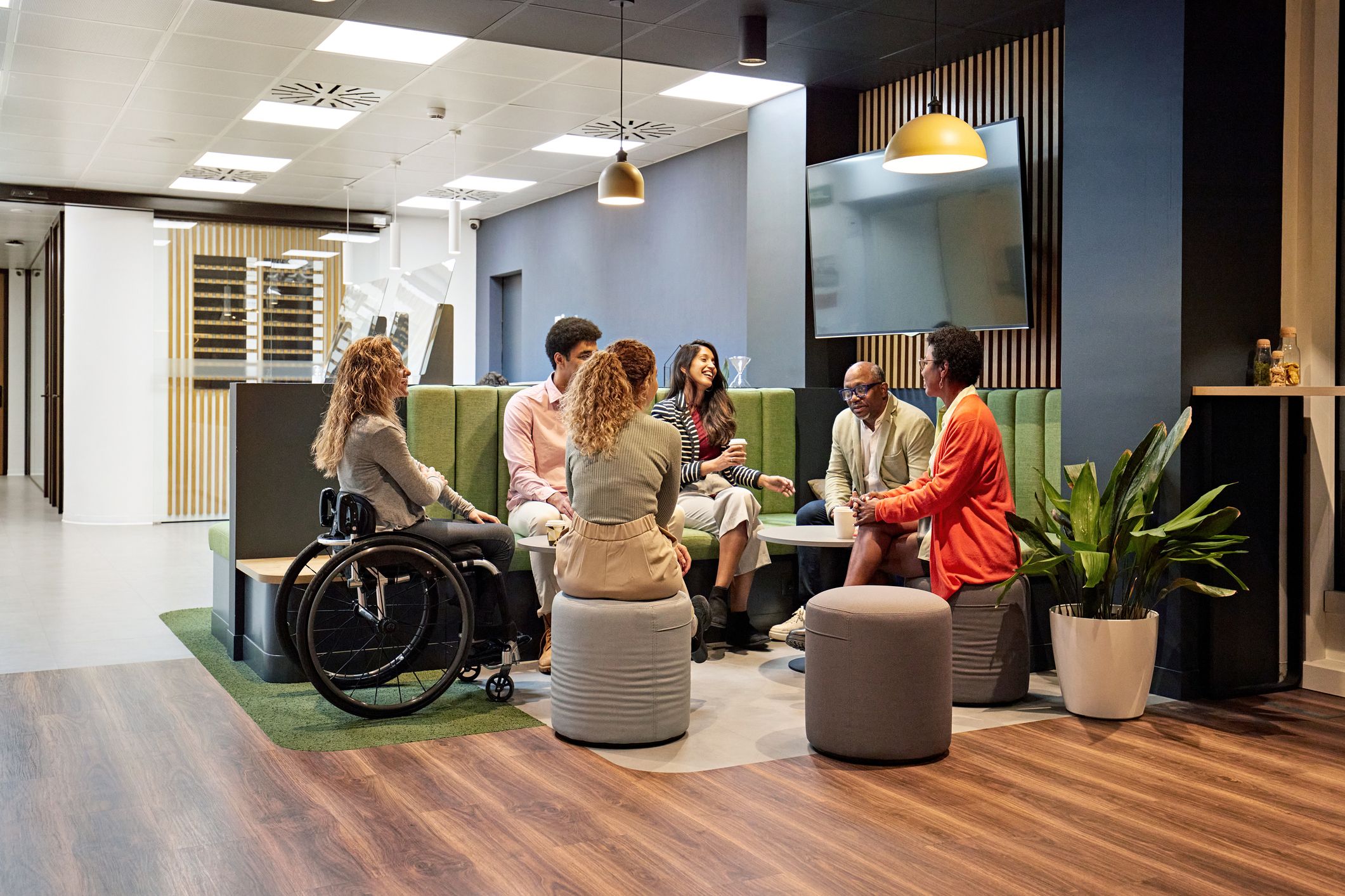 Business team meeting in modern office sitting area - Inclusive Recruitment