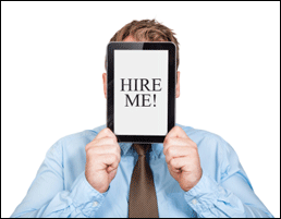 man holding tablet computer in front of face with words 'hire me' on screen